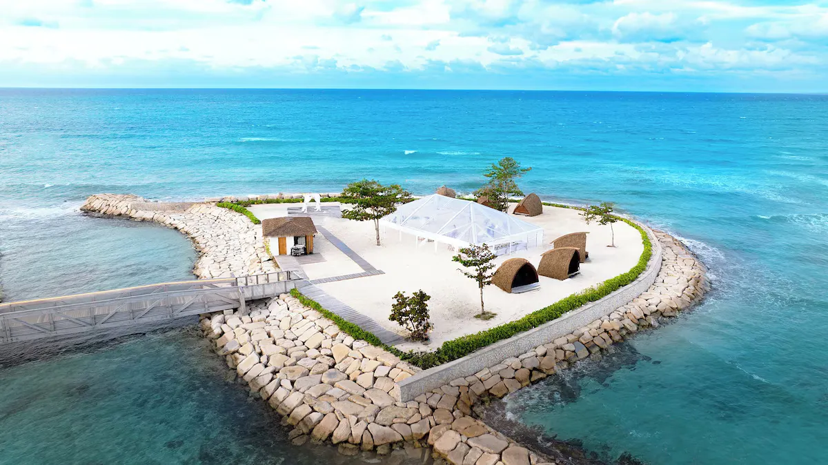 Dream Island from the air, with the marquee, the cabanas and the causeway out to it