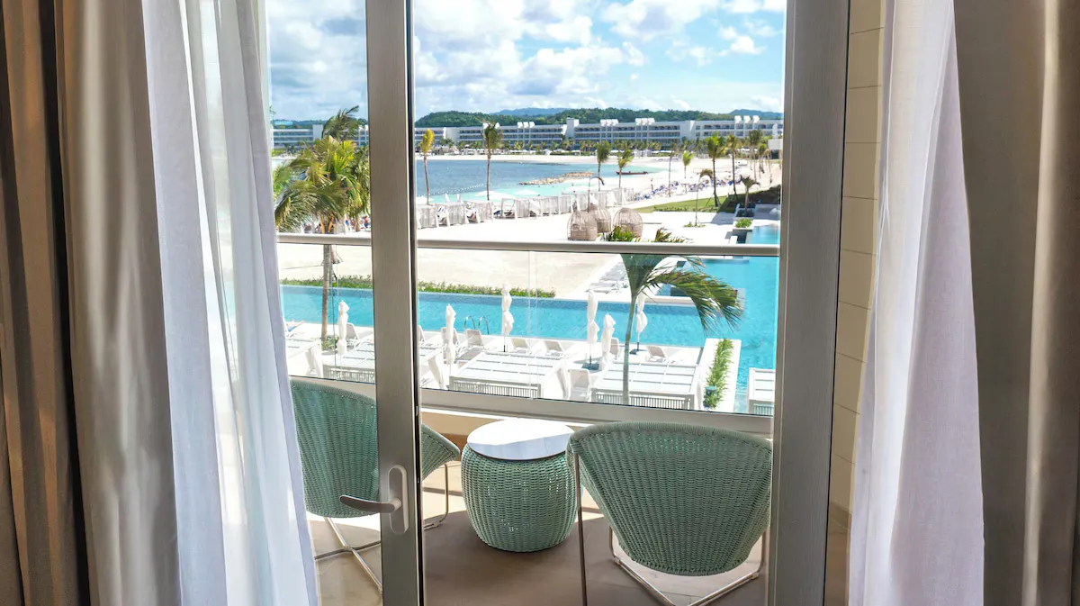 A suite balcony looking out over the pools and the sea